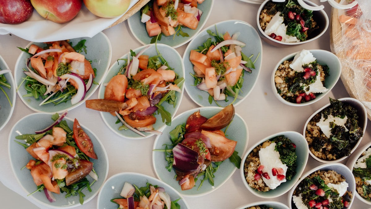 Top view of delicious salads with ripe vegetables prepared for breakfast in daytime